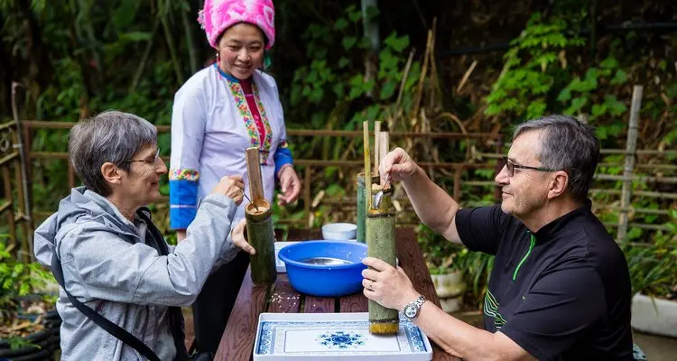 A yao lady sitting by the paddy
