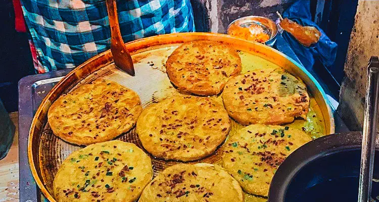 A Naxi lady will teach you how to make a local pancake in their family-run restaurant