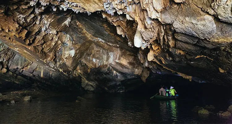 a rowing boat ride through amazing tunnel cave