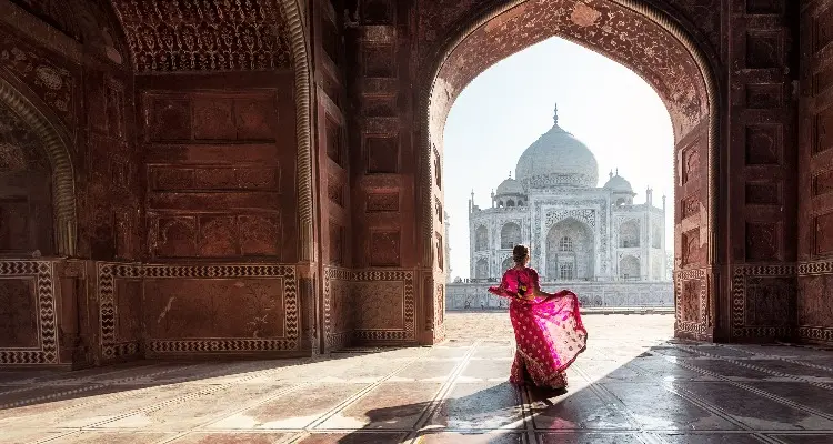 a lady with pink dress at Taj Mahal